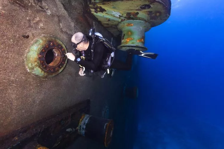 A scuba diver explores the nooks and crannies of the Wit.